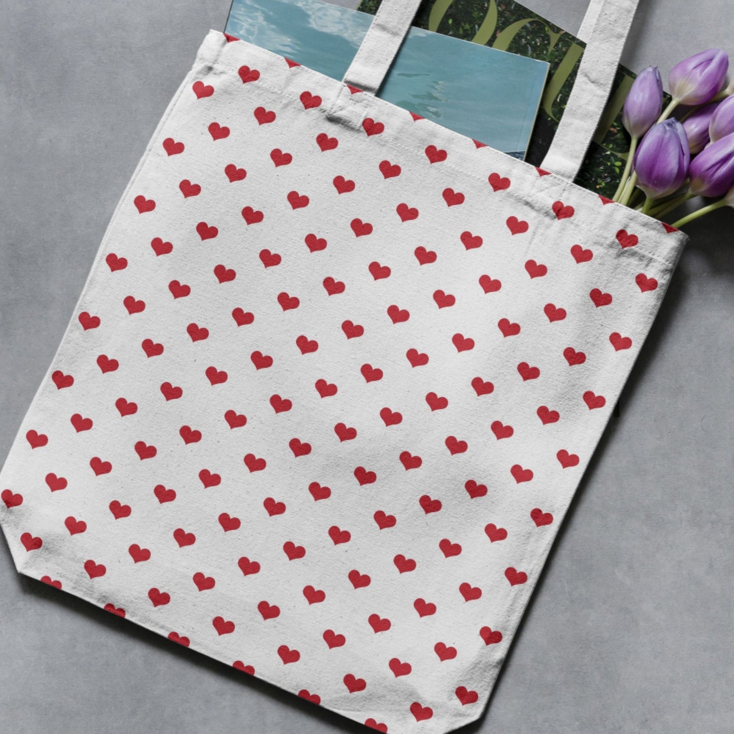 White tote bag featuring a repeating red heart pattern as a finished-product example.