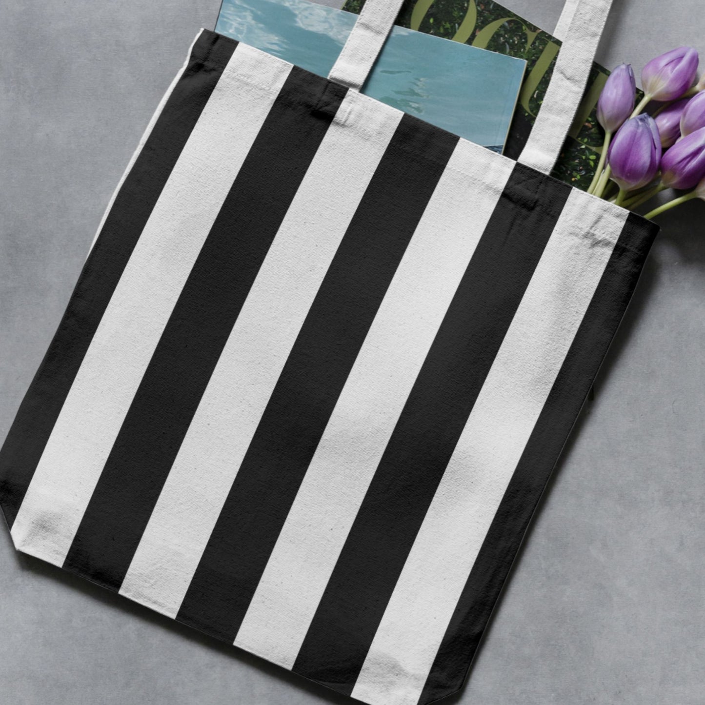 Black and white wide vertical stripe pattern shown on a tote bag mockup