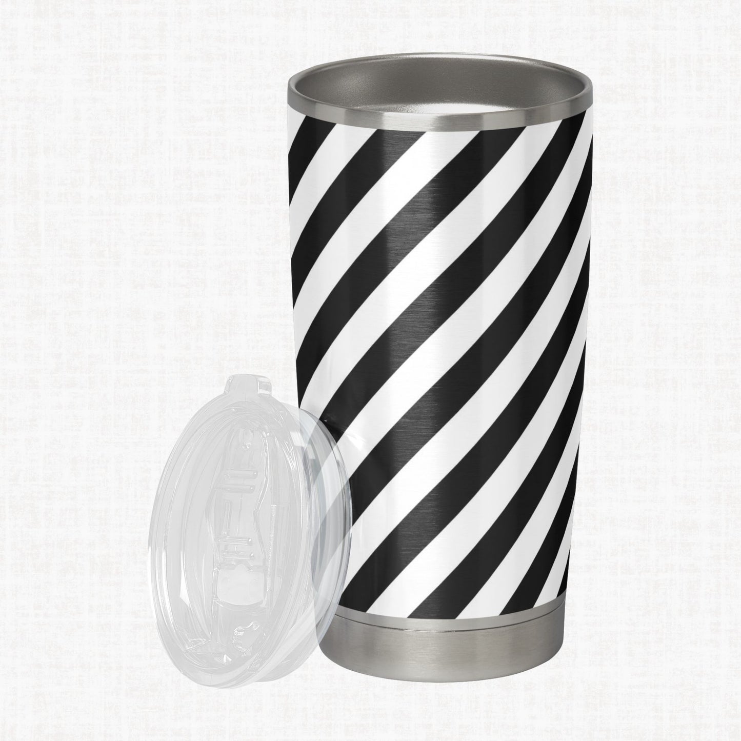 Black and white wide diagonal stripe pattern shown on a stainless steel tumbler as a product-use example.