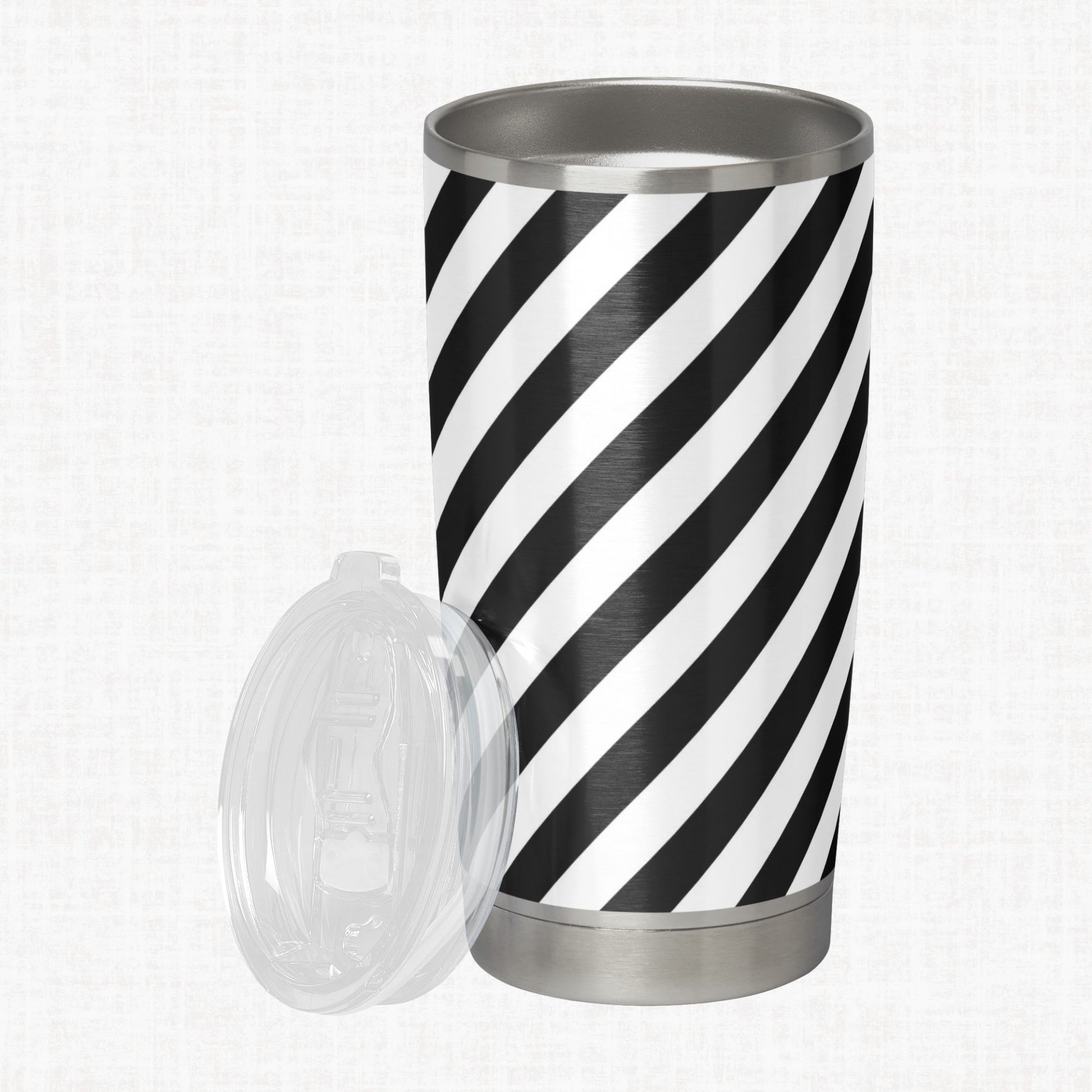 Black and white wide diagonal stripe pattern shown on a stainless steel tumbler as a product-use example.