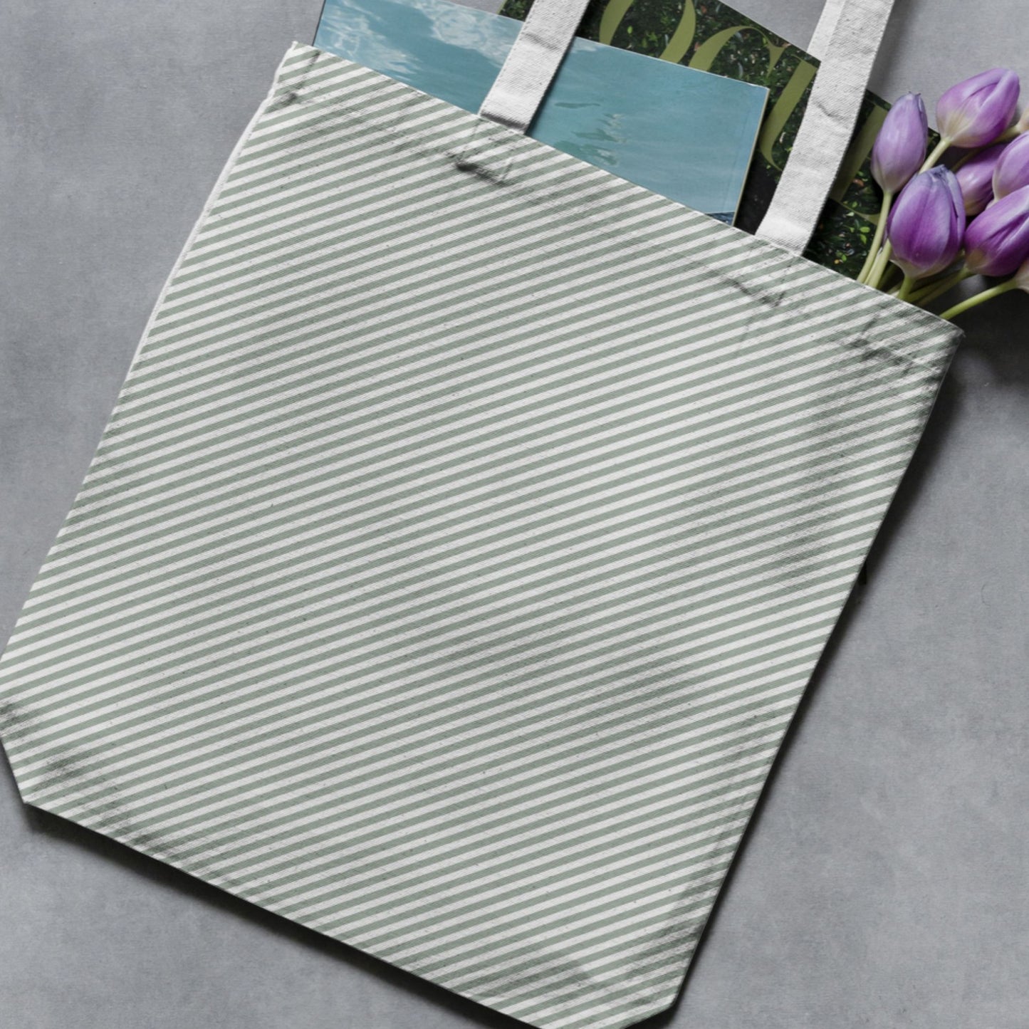 Sage green and white vertical stripe pattern shown on a tote bag as a product-use example.