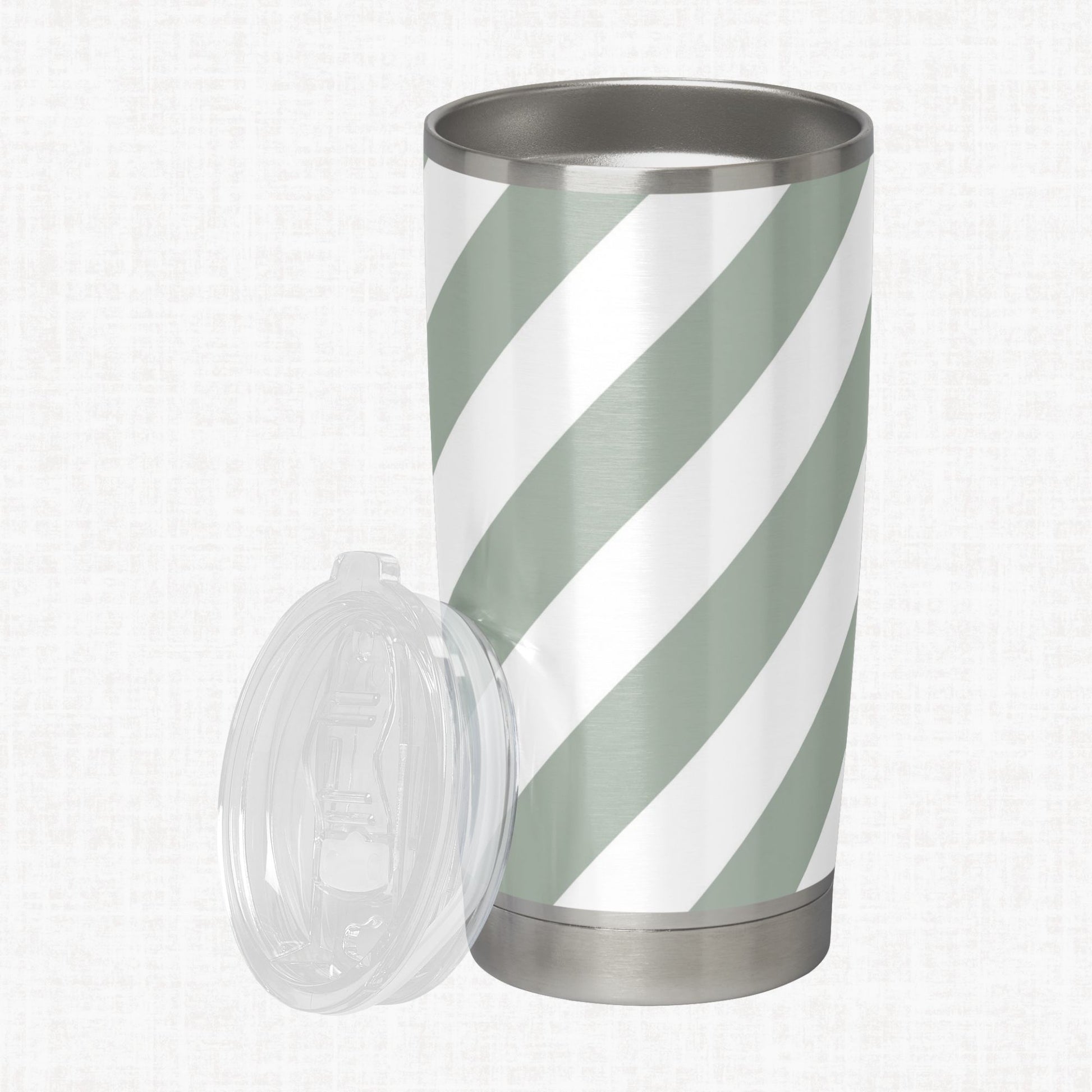 Sage green and white wide diagonal stripe pattern shown on a stainless steel tumbler as a product-use example.