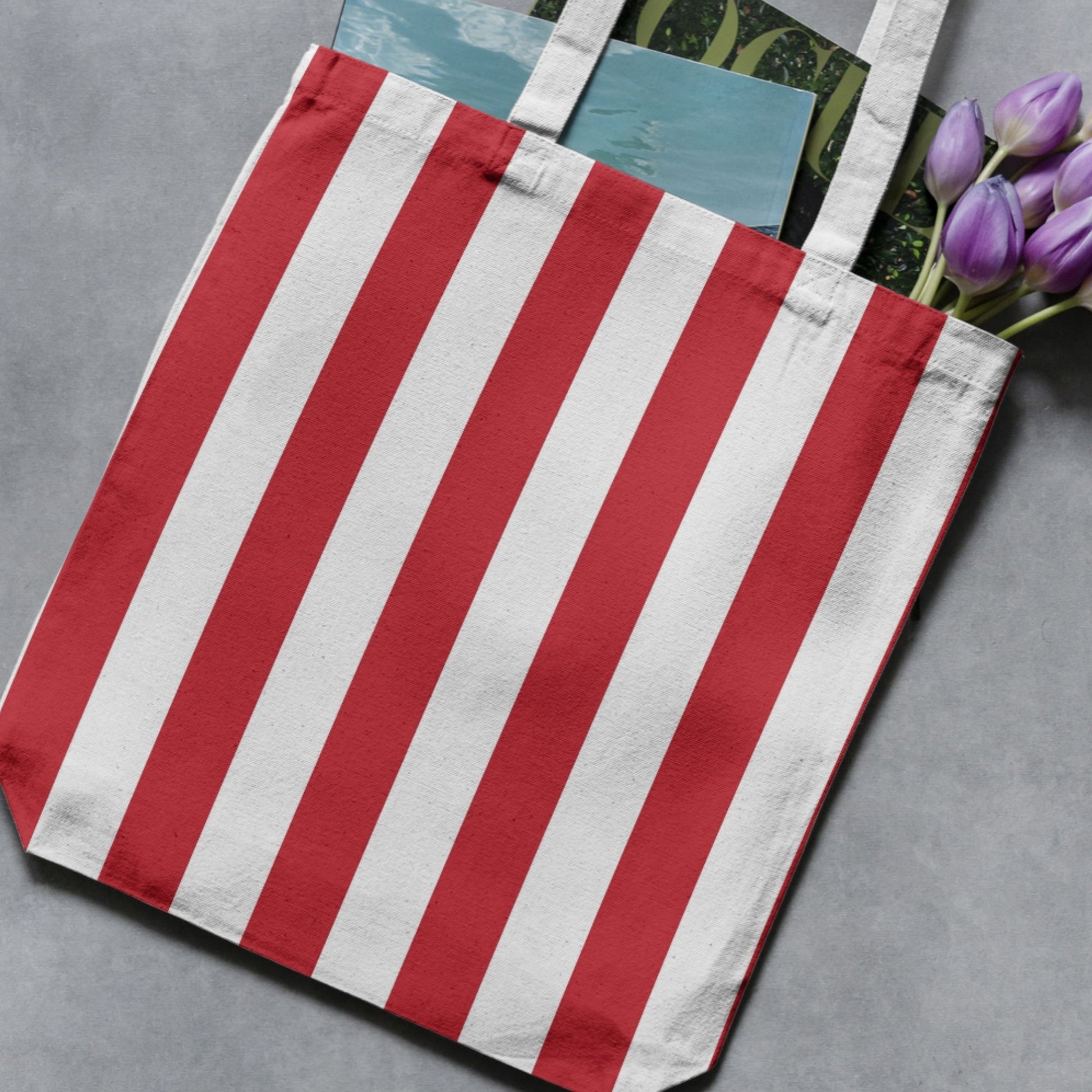 Red and white wide vertical stripe pattern shown on a tote bag as a product-use example.