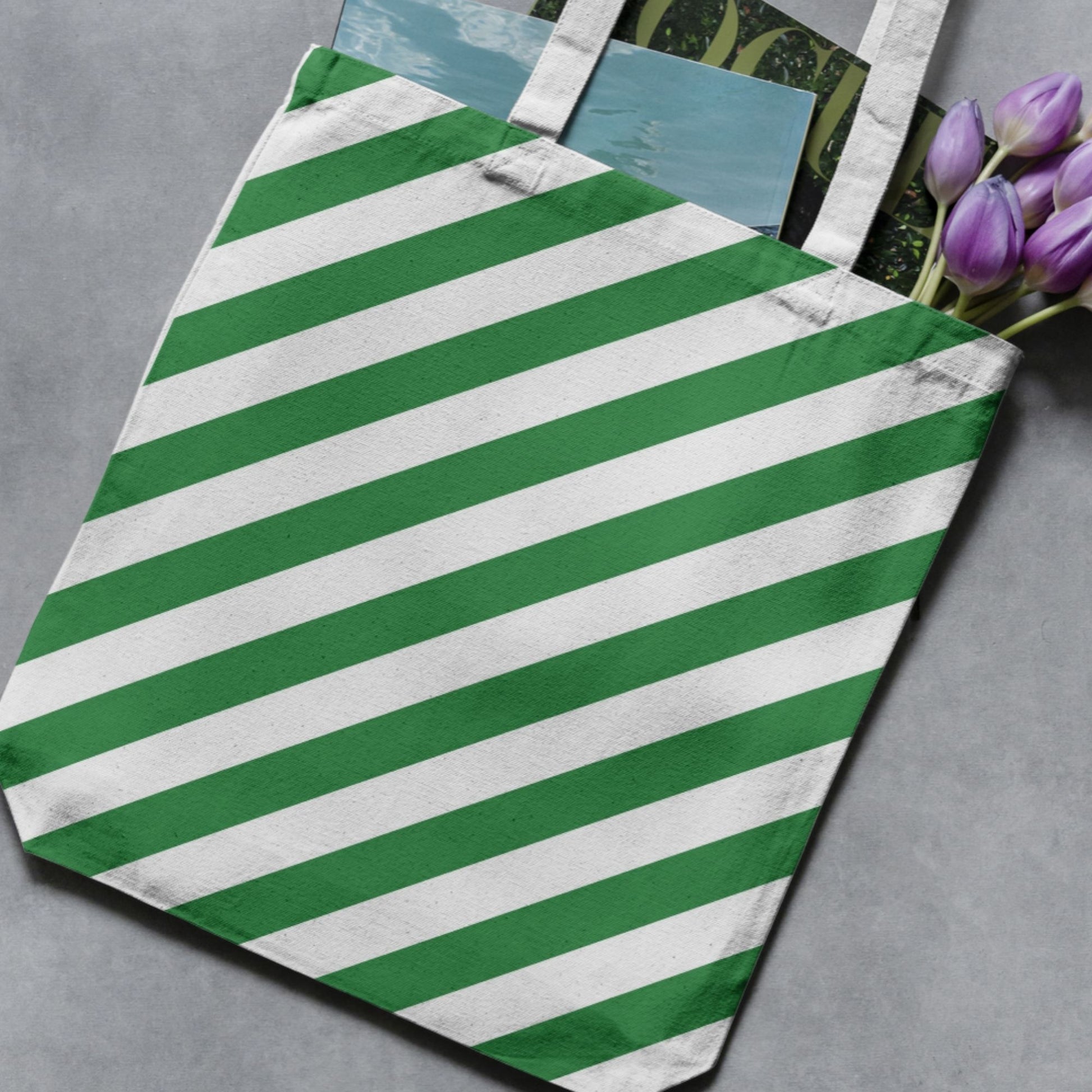 Green and white vertical stripe pattern shown on a tote bag as a product-use example.