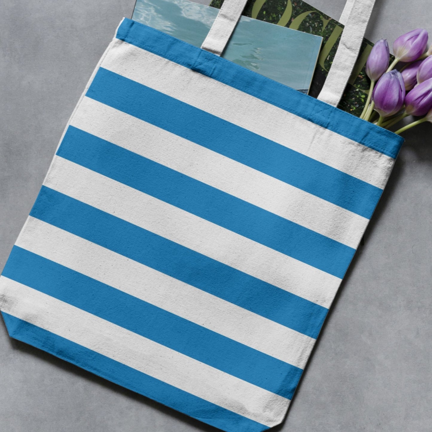 French blue and white wide vertical stripe pattern shown on a tote bag as a product-use example.