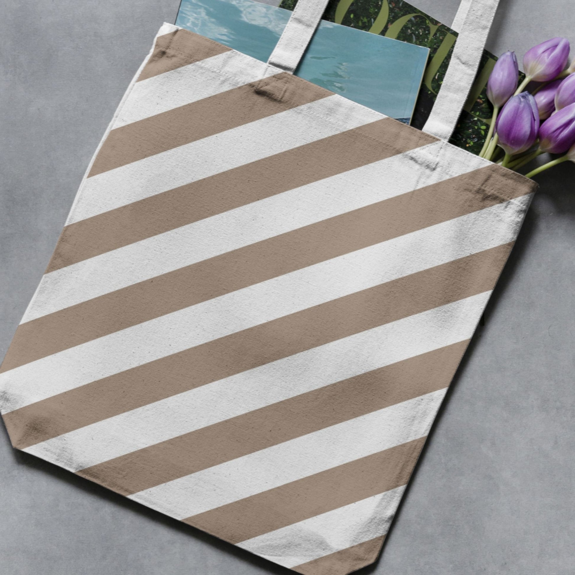 Greige and white wide vertical stripe pattern shown on a tote bag as a product-use example.